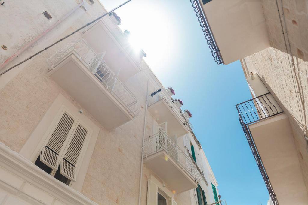 Balconies and white stone facades in the old town of Monopoli